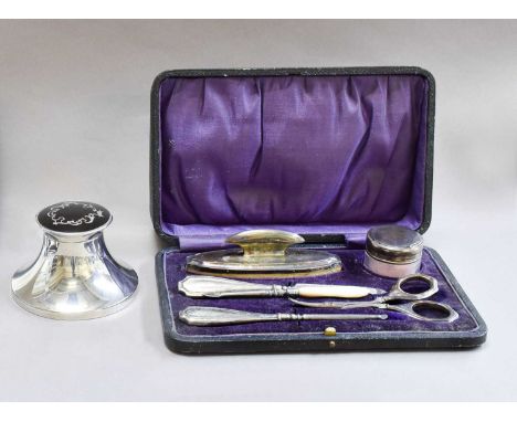 A cased silver and tortoiseshell dressing table set, a silver and tortoiseshell inkwell, and a cased silver manicure set