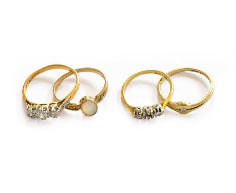 A diamond three stone ring, stamped '22CT', finger size Q; a three stone ring, stamped '18CT', finger size K1/2 (a.f.); a 9 c