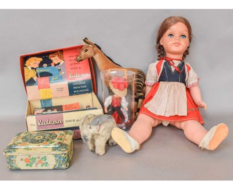 A Steiff Okapi, similar elephant, Vulcan junior sewing machine, and three circa 1960's dolls