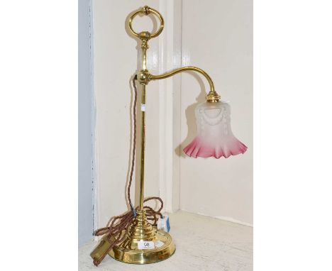 An Edwardian rise and fall lamp with cranberry shadeRise and fall mechanism operating. Shade free from chips and cracks. Some