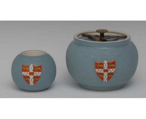 A Carlton Ware University of Cambridge tobacco jar and match strike, both in relief with Coat of Arms, stippled blue ground, 