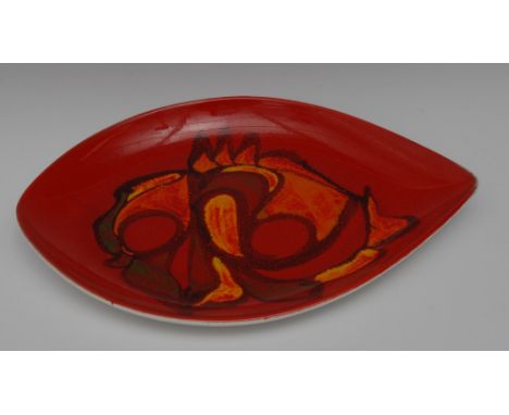 A Poole Delphis arrow head plate, decorated by Anne Godfrey, applied with a stylised fish motif, in bright red and orange ton