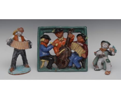 A Continental Art Pottery figure, of a traveller playing an accordion, 26cm high;  another, of a jolly tramp, with floral pos