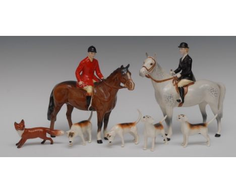 A Beswick hunting set, comprising a mounted huntsman, model no. 1501, a huntswoman mounted on a dapple grey, model no. 1730, 