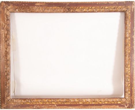In carved and gilded wood, with red polychromy on the edges. Exterior measurements: 151 x 121, light measurements: 129 x 97