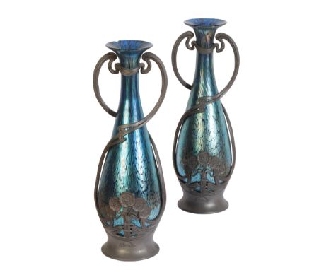 A PAIR OF LOETZ ART NOUVEAU PEWTER MOUNTED VASESthe blue iridescent glass housed within a stylised poppy metal cage, stamped 