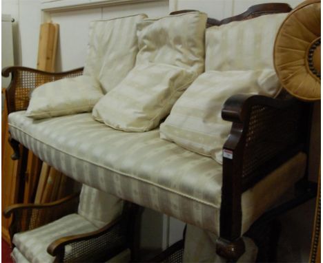 A 1920s walnut and cane inset Bergere suite comprising three seater sofa and pair of armchairs 