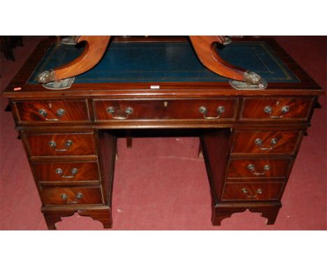 A reproduction mahogany and gilt tooled leather inset twin pedestal writing desk 