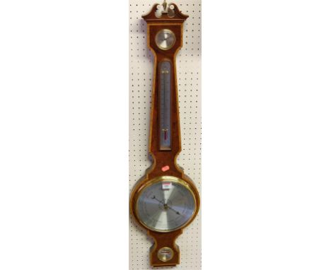 A reproduction figured walnut and satinwood crossbanded four dial wheel barometer 