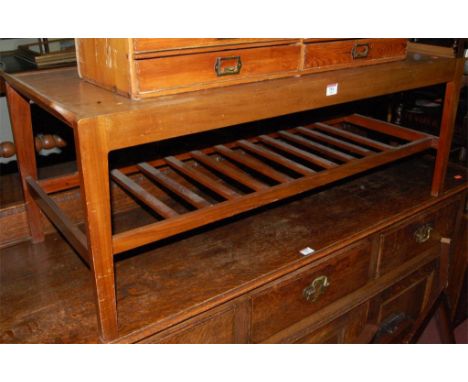 A 1970s teak drawleaf coffee table, having ladder-rack undertier 