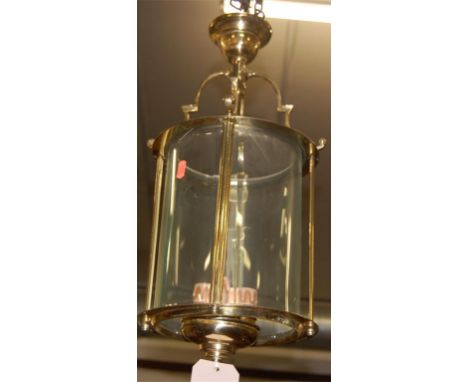 A gilt brass hanging ceiling light of circular form