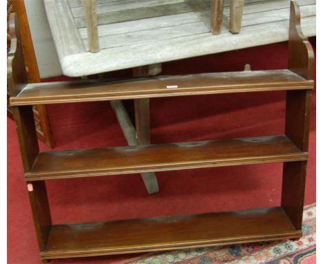 A walnut three tier hanging wall shelf 