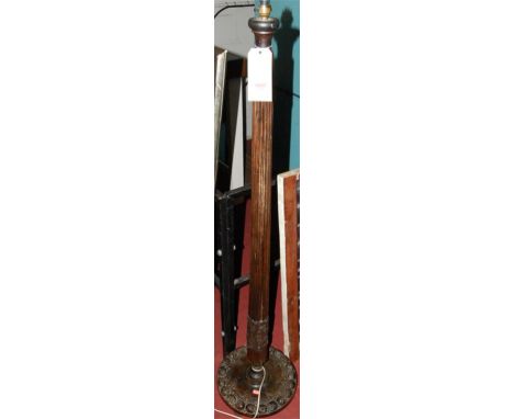 A stained wooden fluted standard lamp 