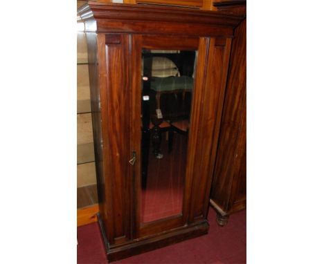 A Victorian mahogany and bevelled glass single mirror door wardrobe 