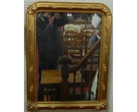 A 19th century giltwood framed wall mirror, the rectangular plate within an ogee moulded and flowerhead applied surround, 87 