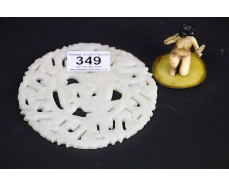 Moulded nude semi-seated figure of a Chinese lady holding a mirror together with jade type carved circular panel, diameter ap