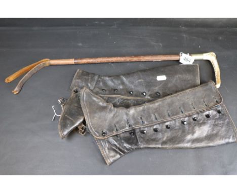 A vintage riding crop, pair of Leather Gaitors and Two Polo Helmets