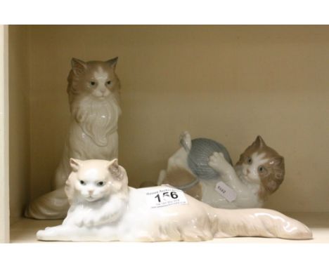 Three Nao ceramic cats to include one playing with a ball of Wool