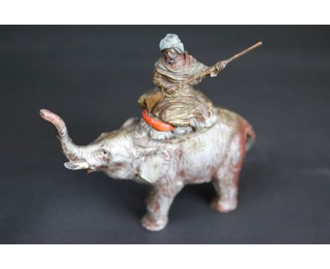 Cast metal painted Arab figure holding musket seated on an elephant with raised trunk, circa 1920s/1930s, indistinctly stampe