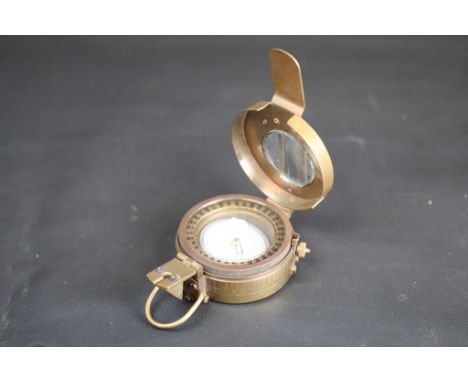 Military style reproduction brass compass, dimensions approximately 10cm by 6.5cm