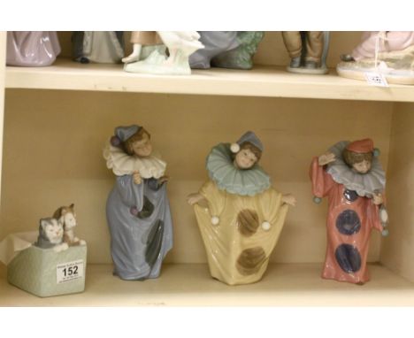 Three Nao Clown figurines and a cats in a box model