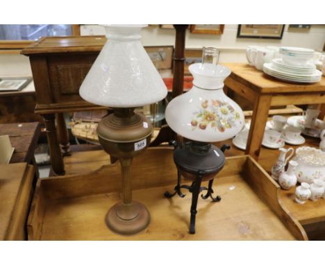 Brass Oil Lamp with Opaque Floral Decorated Shade together with a Brass and Wrought Iron Oil Lamp with matched shade 