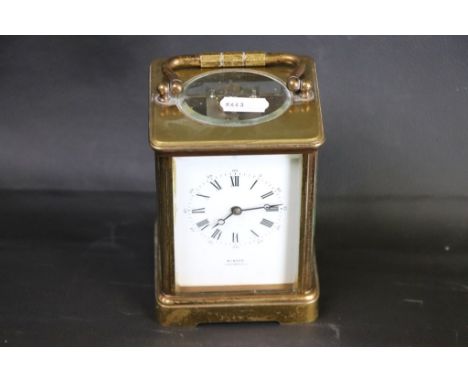 19th century brass carriage clock the white enamel dial inscribed Winder Eastbourne, black Roman numerals and Arabic numerals