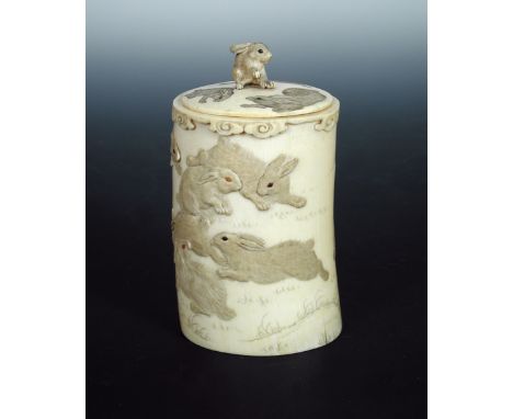 A late 19th/early 20th century ivory covered vase carved in low relief with rabbits playing below the stylised cloud rim band