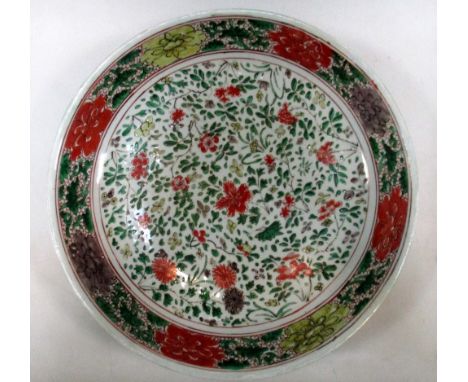 A famille verte dish, period of Kangxi, the interior painted with scattered chrysanthemums, cherry and peony with ina rim ban