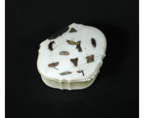 A Shibayama snuff box together with three smaller ivory pieces, the hinged shell shaped lid inlaid with insects, 7cm (2.75 in