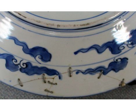 An early 20th century Imari dish another smaller and a collection of five plates, the rim of the first painted with alternati