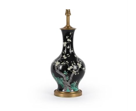 A Chinese Famille Noire vase, late Qing Dynasty, painted with a flowering prunus tree and birds in white and green enamels co