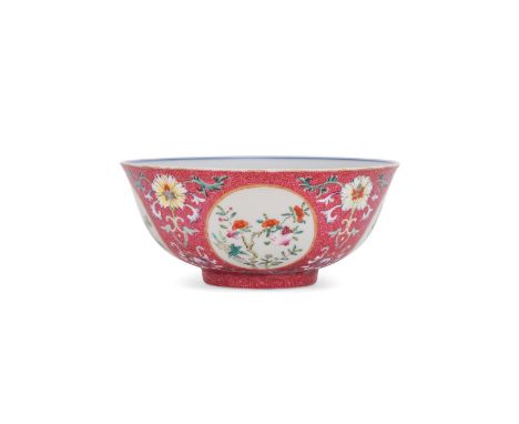 A Chinese Famille Rose bowl, potted with the deep rounded sides rising from a slightly tapered foot to a lipped rim, the exte