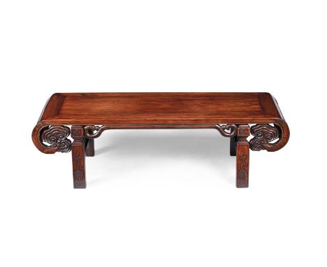 A Chinese hardwood low table, late Qing Dynasty, with craved scroll ends terminating in well carved lingzhi fungus, floral an