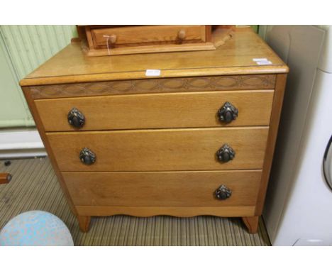 A LOW LIGHT OAK THREE DRAWER CHEST 