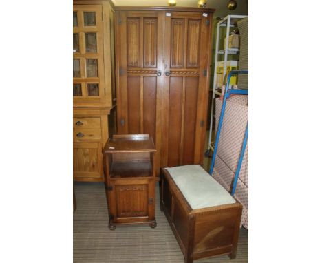 A LIGHT OAK FINISHED BEDROOM SUITE comprising two door fitted wardrobe, single bedside pot cupboard &amp; pad topped box coff