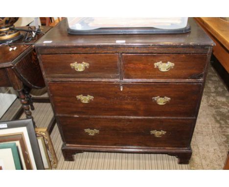 A WOODEN FOUR DRAWER CHEST on plain bracket feet 