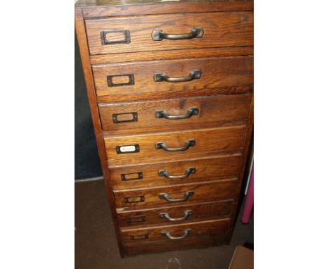 A VINTAGE WOODEN FILING CABINET 