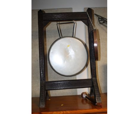 A GONG ON STAND WITH CRICKET BALL ON STICK 