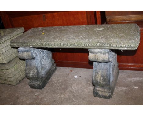 A STONE GARDEN BENCH WITH GRAPE DECORATION 