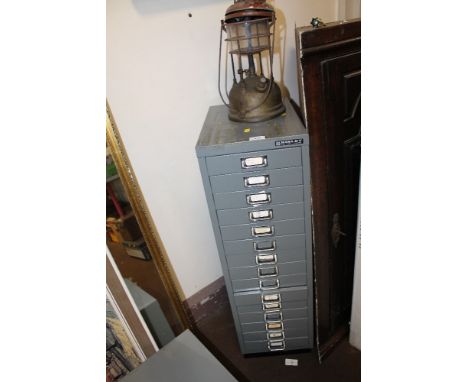 A BISLEY FILING CABINET TOGETHER WITH A VINTAGE PARAFFIN LAMP