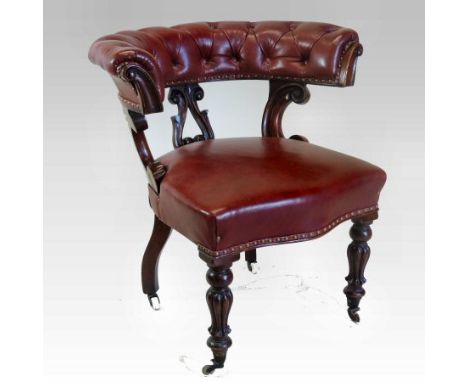 A William IV carved mahogany and red leather upholstered gentleman's library armchair, with a curved button back, on fluted l