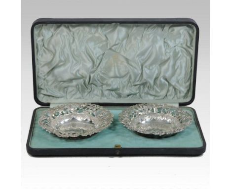 A pair of Victorian pierced silver bon bon dishes, decorated with scrolls and flowers, Birmingham 1893, 11cm diameter, retail