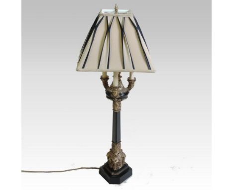 An ornate Empire style bronzed and gilt three branch table lamp, with a cream shade, 91cm high overall