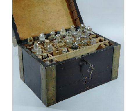 A Victorian stained pine and brass bound apothecary box, with a hinged lid and a fitted interior, with thirty compartments, c