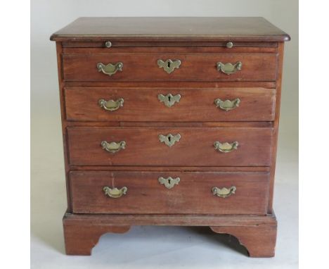 A George III mahogany bachelor's chest, of small proportions, fitted with a brushing slide, above four long graduated drawers