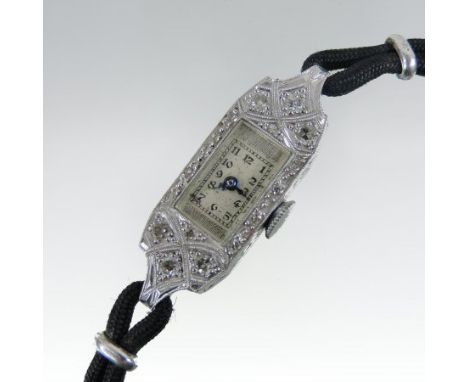 A 1930's platinum and diamond ladies cocktail watch, on a black cord strap