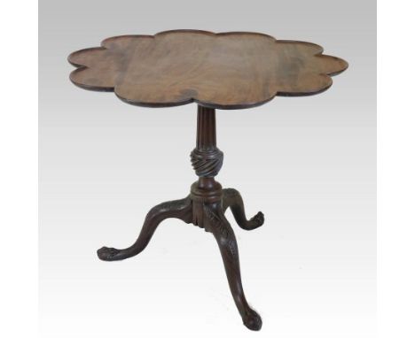 A 19th century mahogany supper table, with a hinged shaped top, on a fluted baluster column and an acanthus carved tripod bas