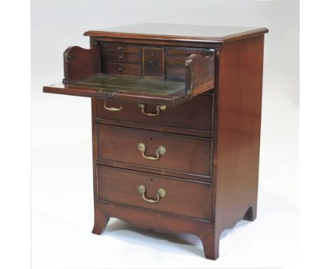 A George III style mahogany secretaire chest, with a hinged fall and fitted interior, above three drawers, on swept bracket f