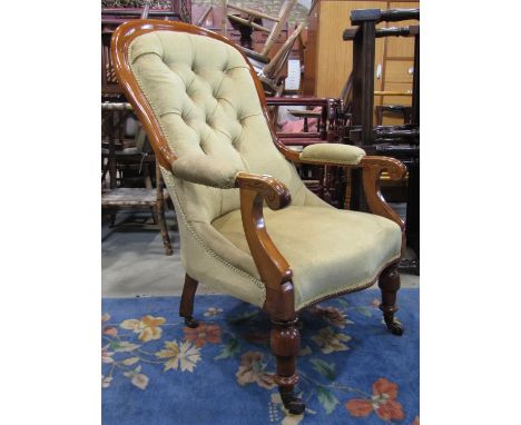 A Victorian spoon back drawing room chair with upholstered serpentine shaped seat, button back and arm pads within a moulded 